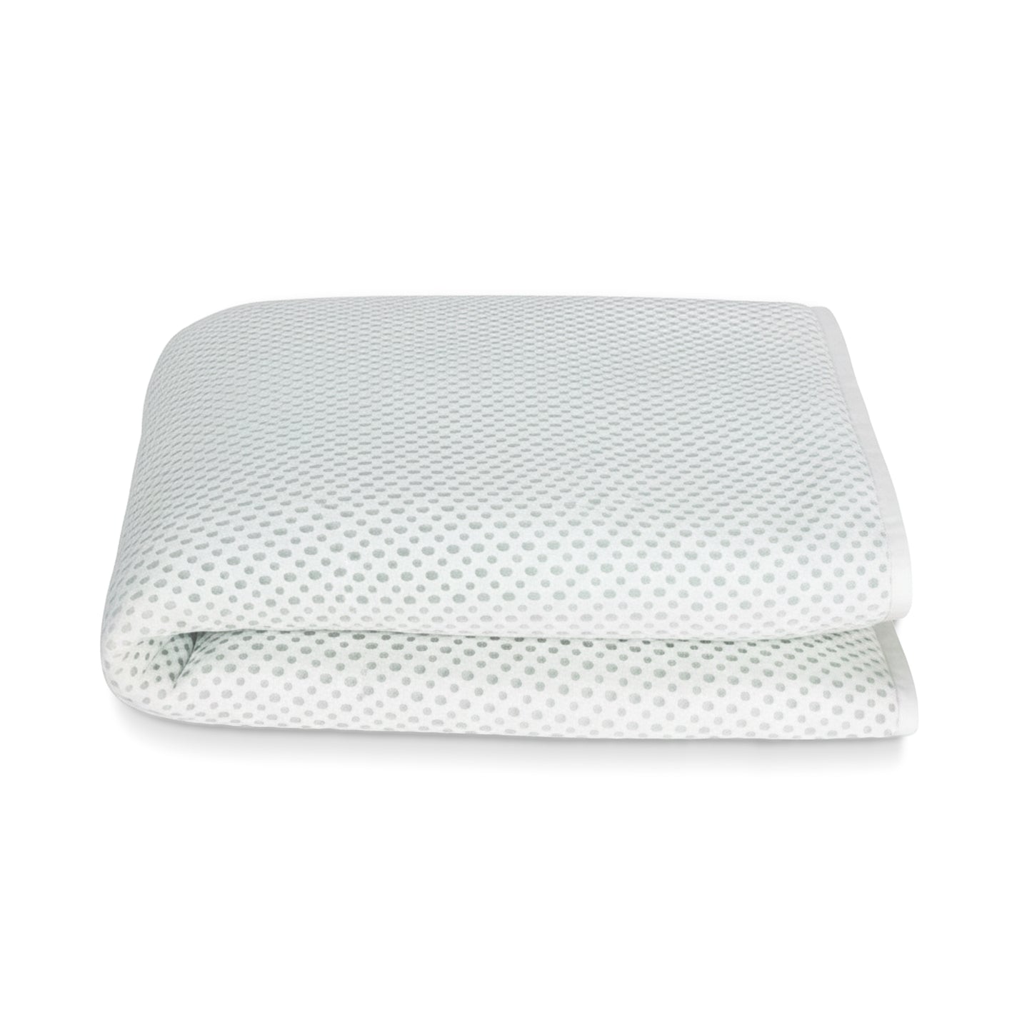 The Newton Baby Essential Waterproof Crib Pad, featuring a white breathable design with subtle gray dots, is shown folded against a plain white background.