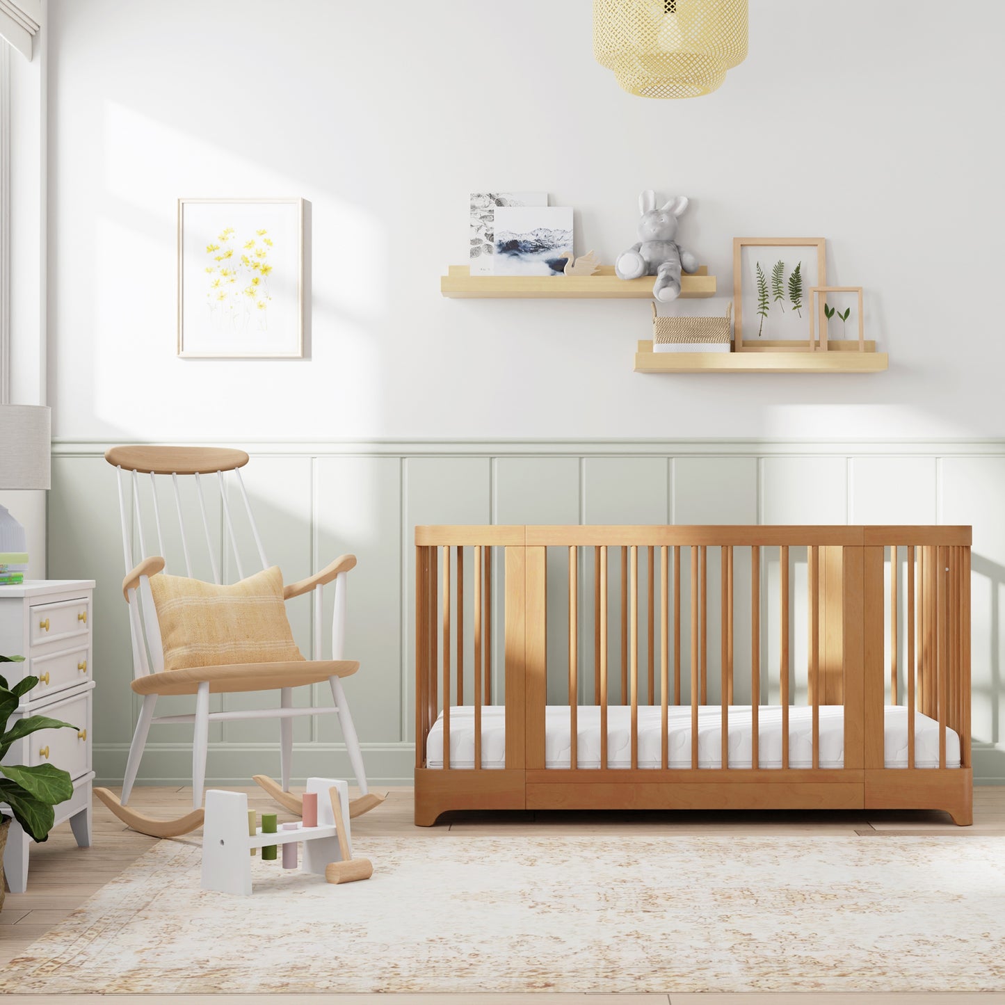 Natural color Newton Nest Convertible Crib in crib setting, in nursery next to rocking chair