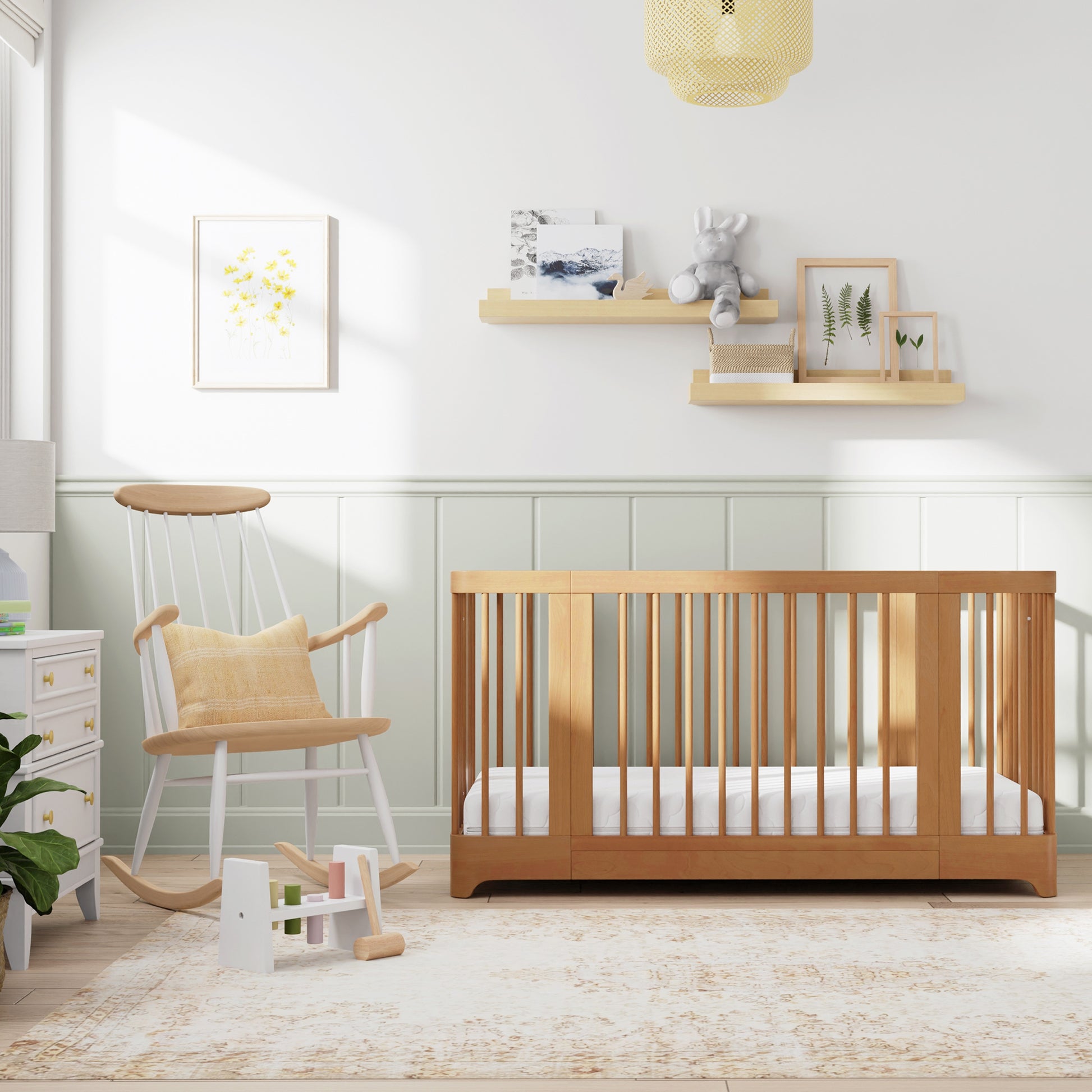 Natural color Newton Nest Convertible Crib in crib setting, in nursery next to rocking chair