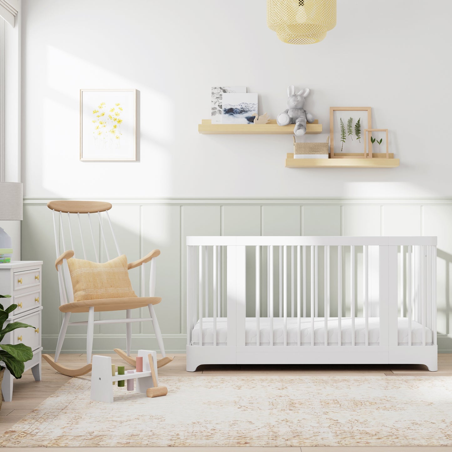 White color Newton Nest Convertible Crib in crib setting, in nursery next to rocking chair