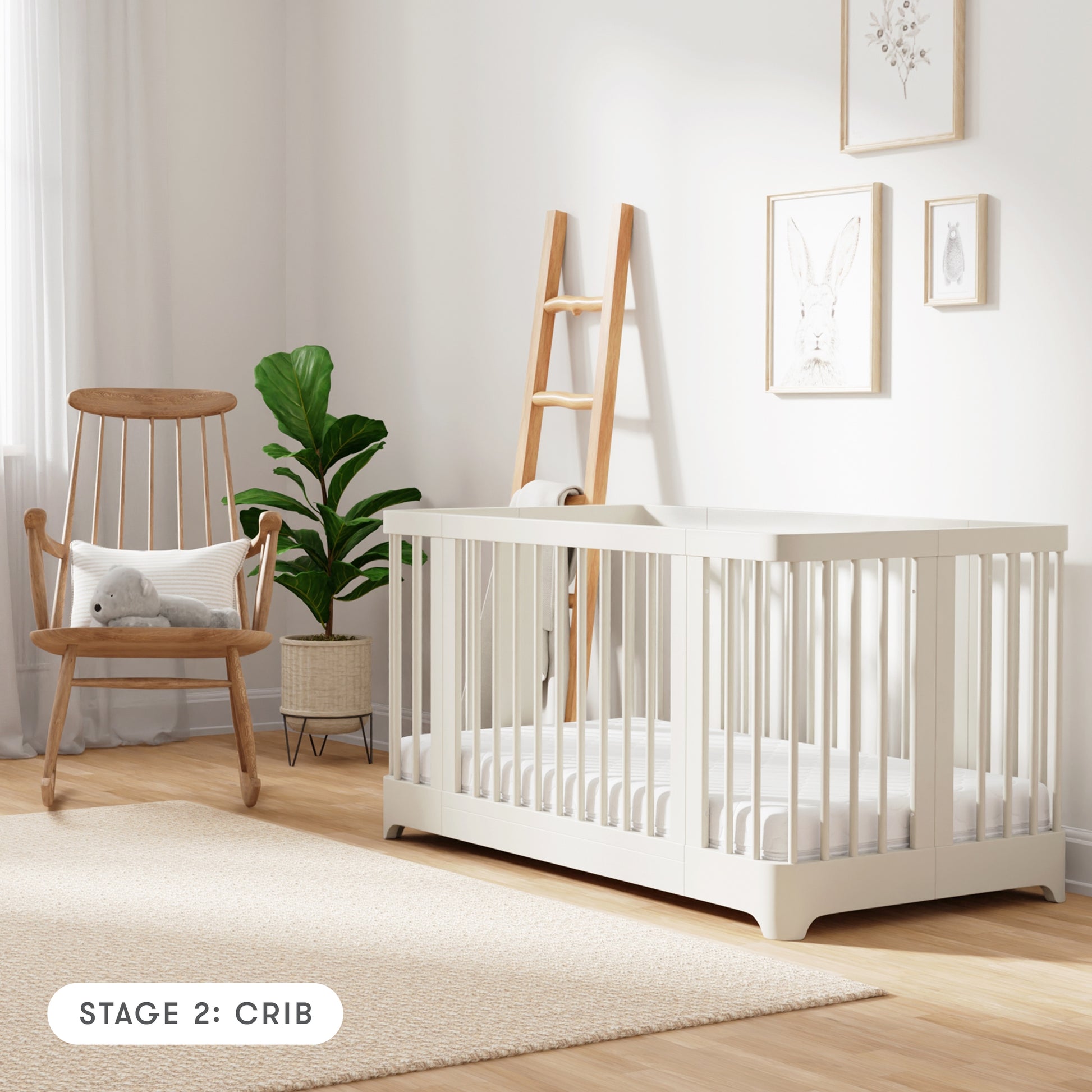 warm white color Newton Nest Convertible Crib in crib setting, in nursery next to rocking chair, with text "Stage 2: Crib"