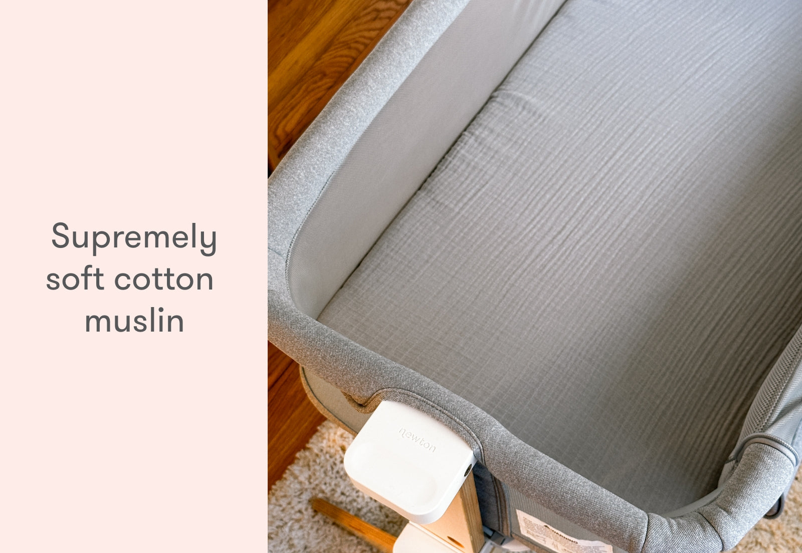 Top-down view of a baby cot made of supremely soft cotton muslin, placed on a wooden floor.
