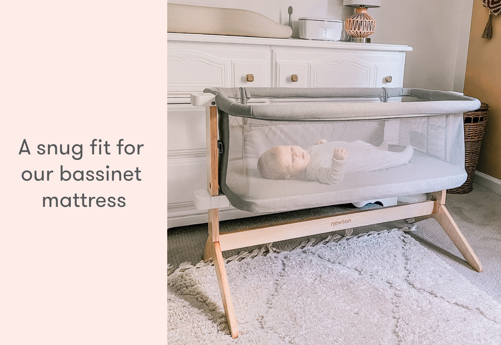 Infant resting peacefully in a bassinet with text stating "A snug fit for our bassinet mattress" set in a cozy bedroom ambiance.