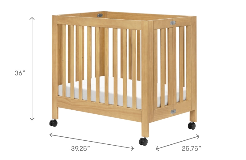 Wooden baby crib on wheels with dimensions 36 inches in height, 25.75 inches in depth, and 39.25 inches in length displayed.