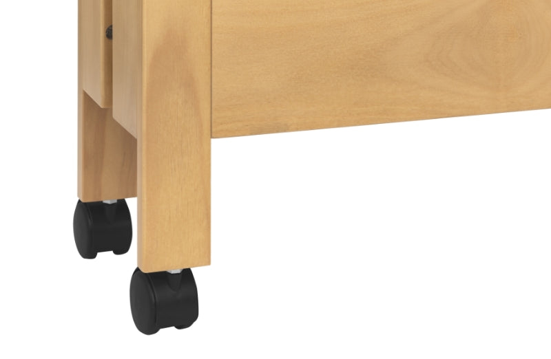 Close-up view of the wooden legs of a baby crib on black caster wheels.