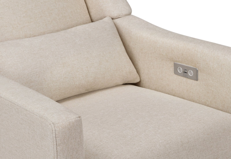 Close-up view of a beige upholstered sofa with two pillows, featuring a built-in USB charging port on the armrest.