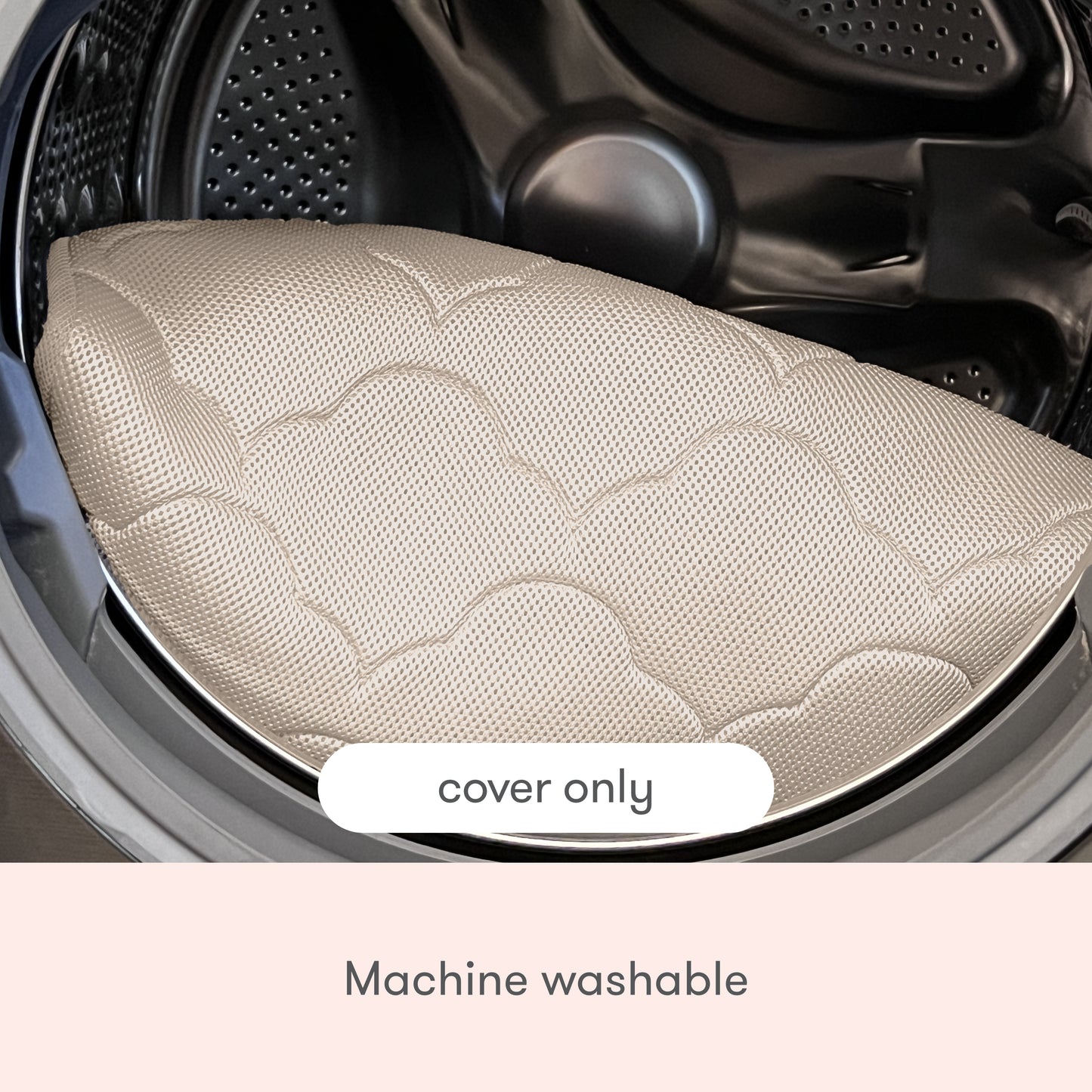 A close-up of an Extra Bassinet Mattress Cover by Newton Baby in beige inside a washing machine drum. Text on the image reads cover only and machine washable.