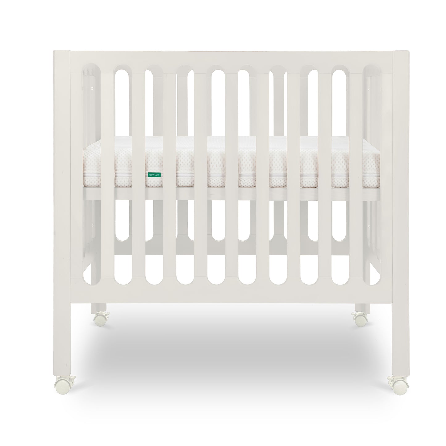 Warm White modern baby crib with a thin mattress on wheels.