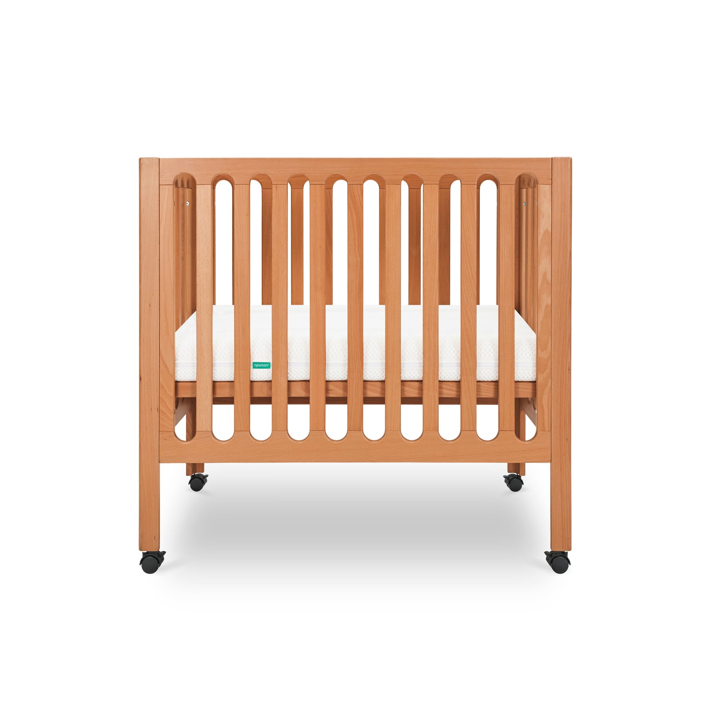 Modern wooden crib on wheels with visible mattress, isolated on a white background.