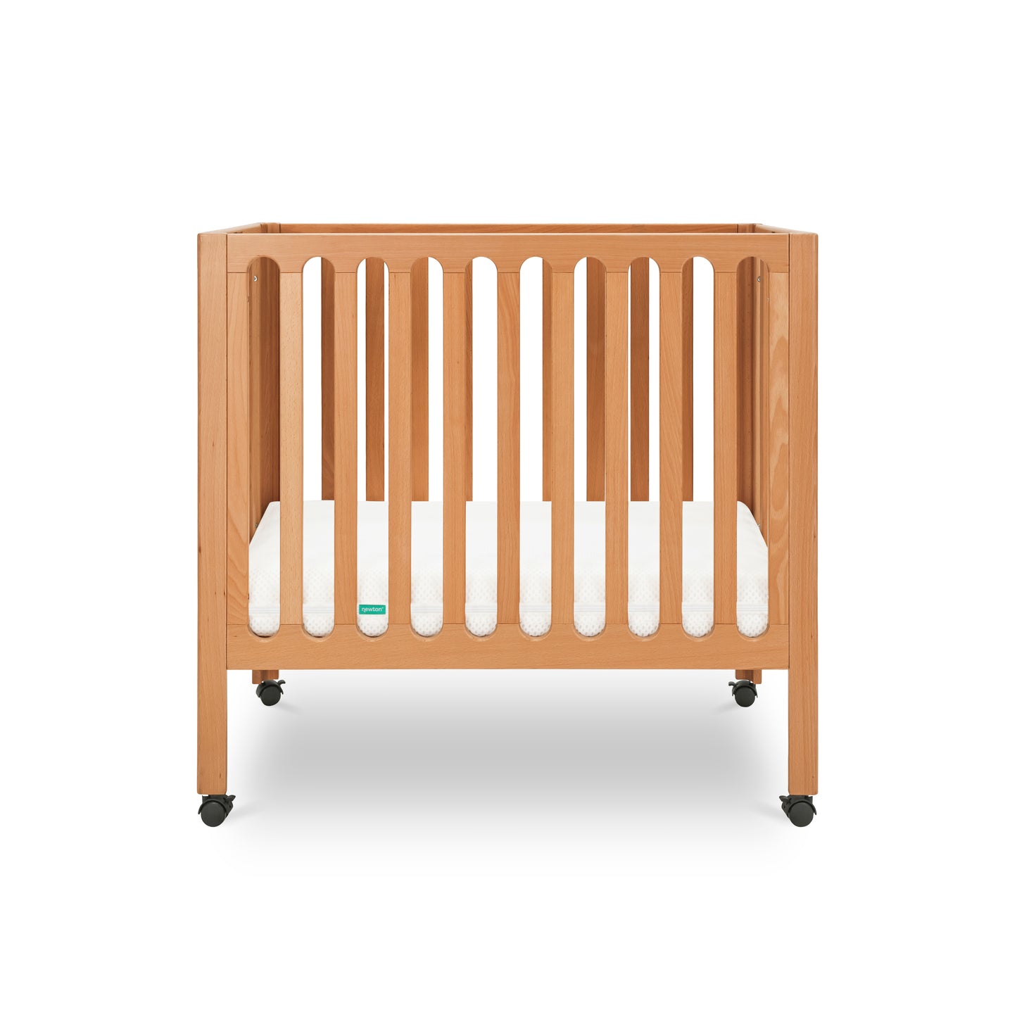 Modern wooden crib on wheels with visible mattress, isolated on a white background.