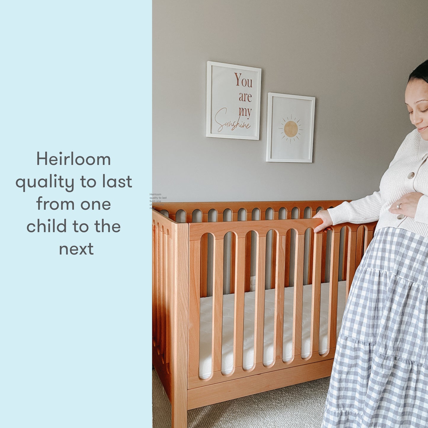 A smiling woman touches a wooden crib in a nursery, next to text that reads "Heirloom quality to last from one child to the next."