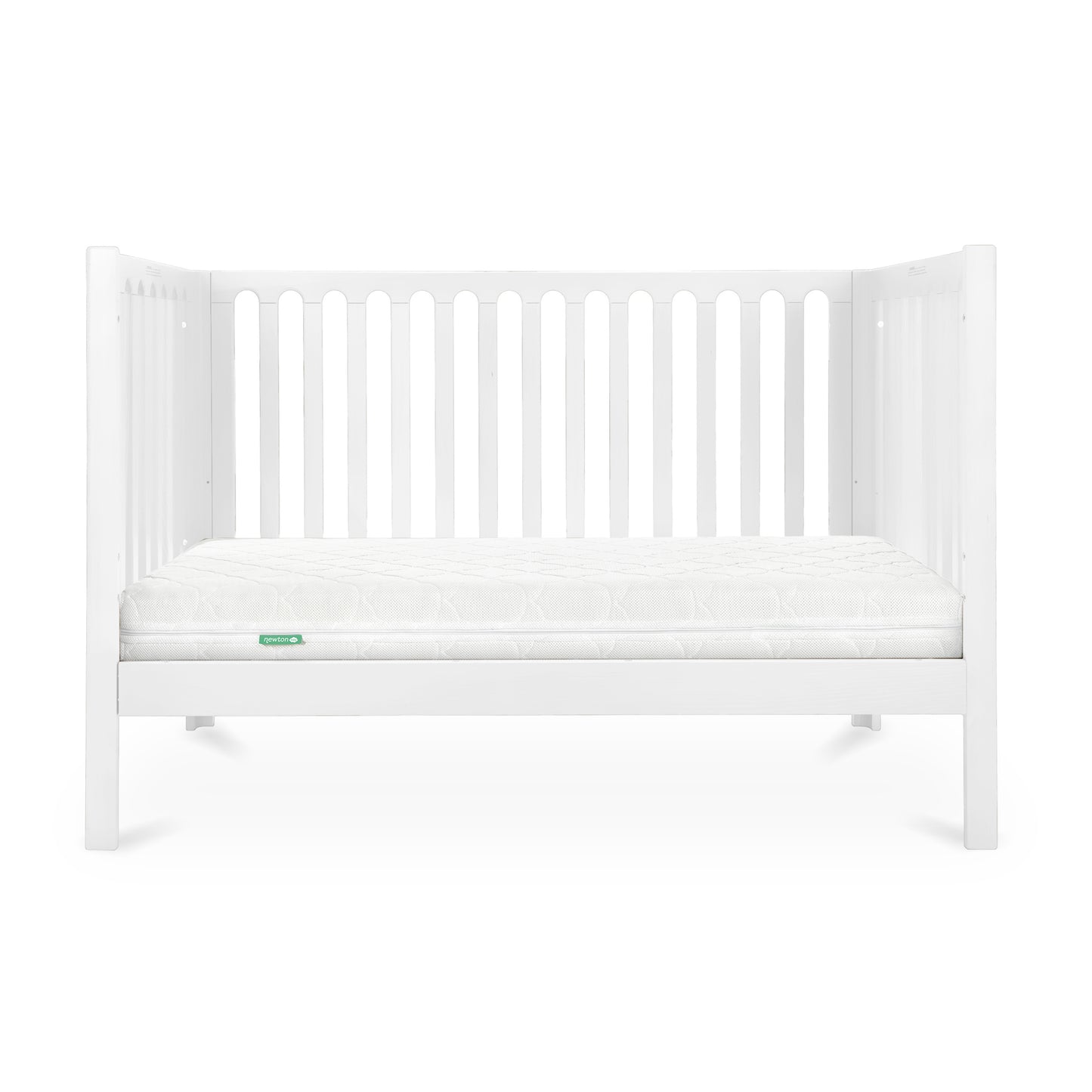 A simple white baby crib with a clean mattress displaying a small green 'Newton' logo on its corner.
