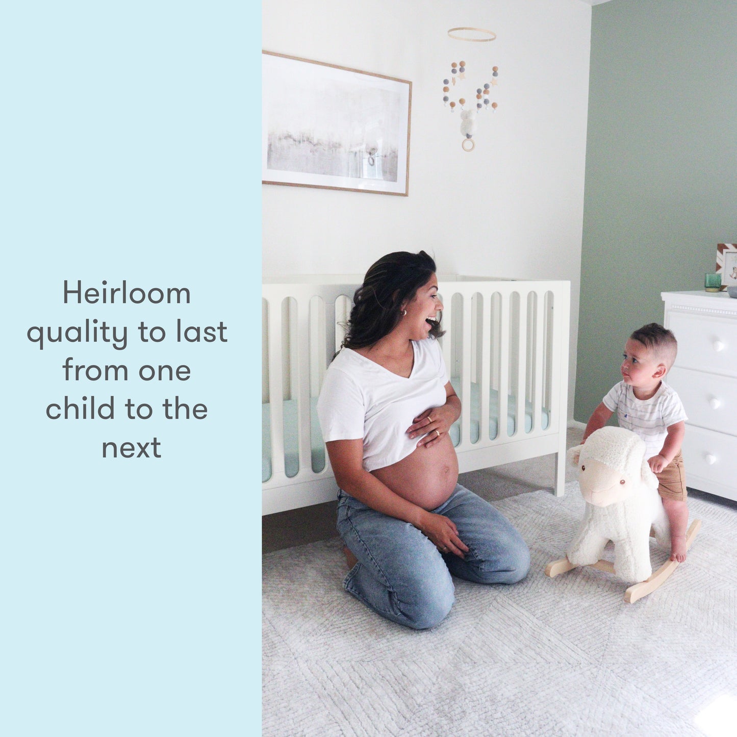 A pregnant woman kneeling smiles at a young child playing with a wooden toy in a nursery room with text stating "Heirloom quality to last from one child to the next."