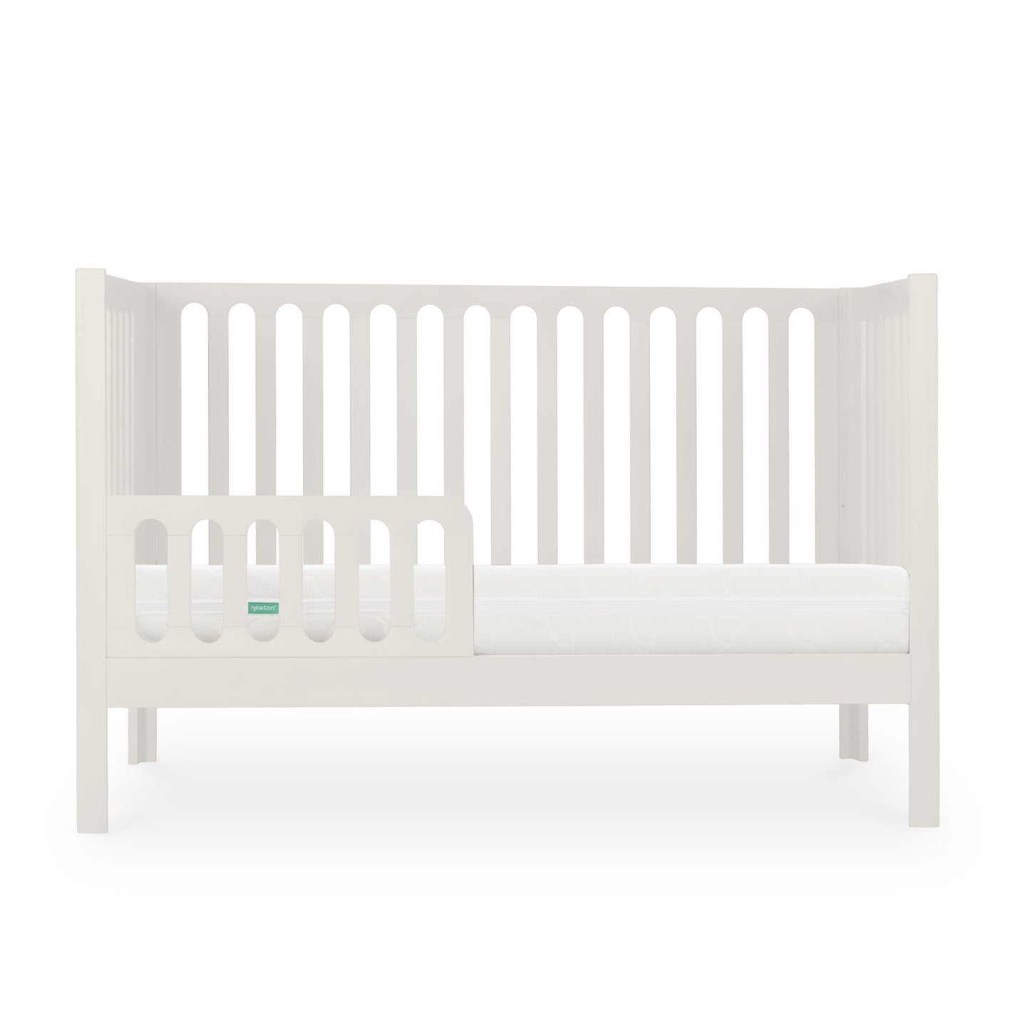 White modern baby crib with a Newton mattress visible, styled with minimalistic design on a plain background.