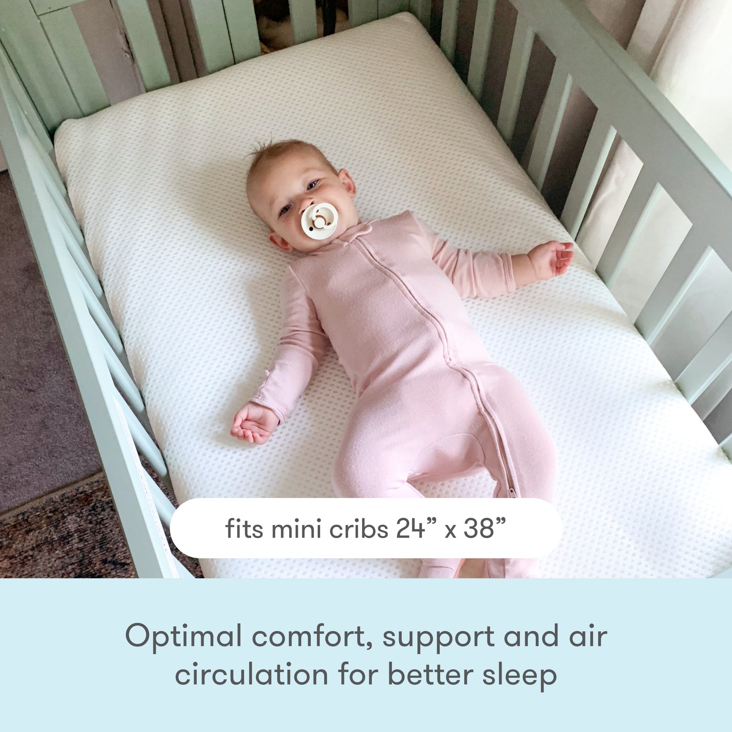 Baby in pink onesie resting on a breathable mattress in a crib, with text "Optimal comfort, support and air circulation for better sleep".