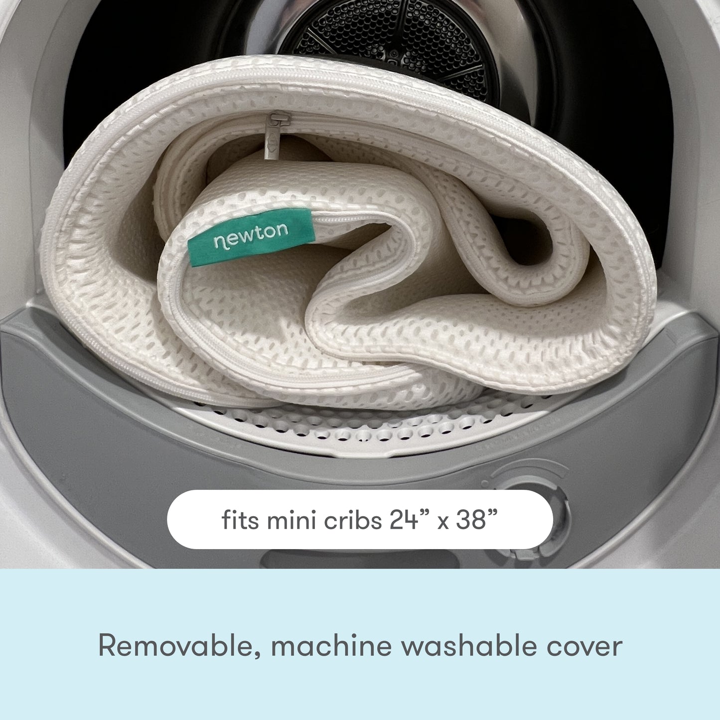A removable, washable Newton baby mattress cover coiled inside a washing machine, with text "Removable, washable cover" displayed at the top.