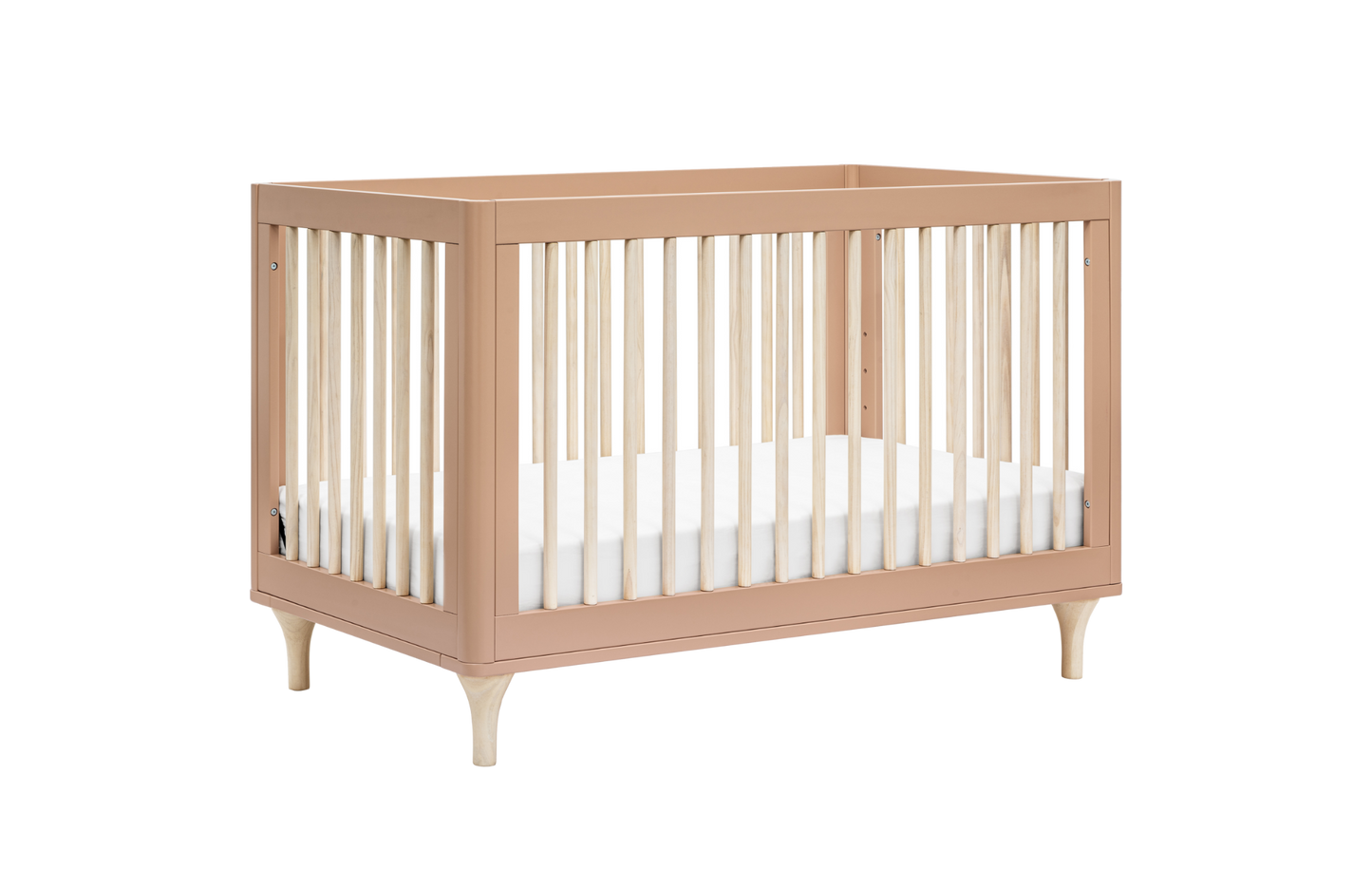 The Babyletto Lolly Convertible Crib features light wood legs, pale New Zealand pine slats, a light brown frame, and a white mattress, all set against a plain white background.