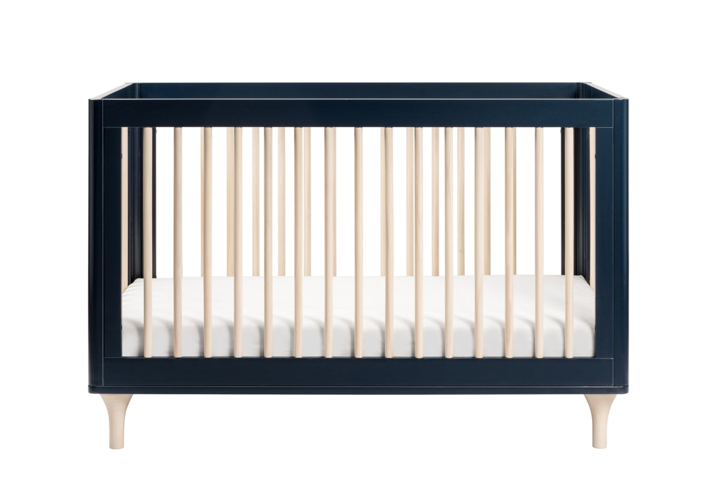 Elegant navy blue baby crib with contrasting light wood spindles and a white mattress, isolated on a white background.