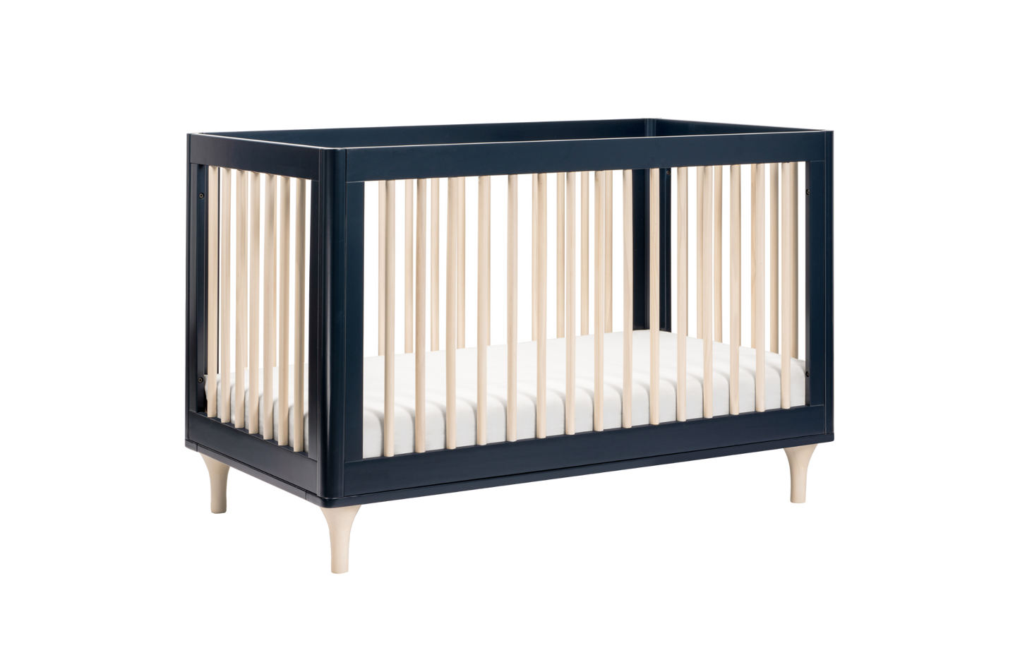 The Babyletto Lolly Convertible Crib features a sleek dark blue frame, natural wood slats, and a white mattress. Crafted from New Zealand pine wood, it offers clean lines and minimalist style for modern nurseries.