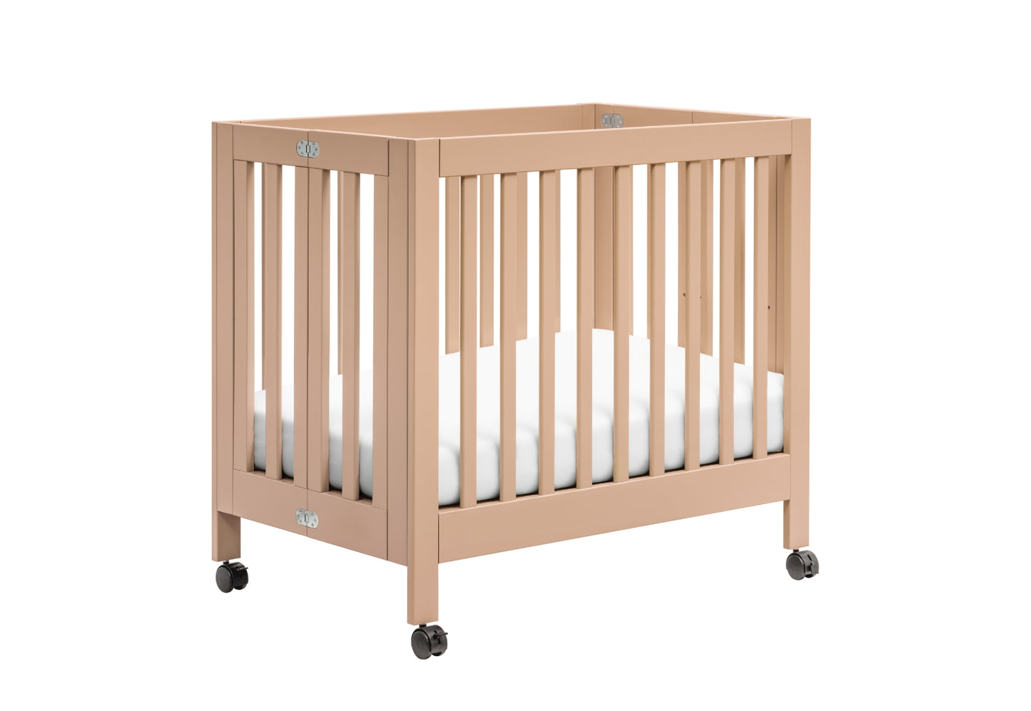 A modern beige wooden baby crib on wheels with a visible white mattress.