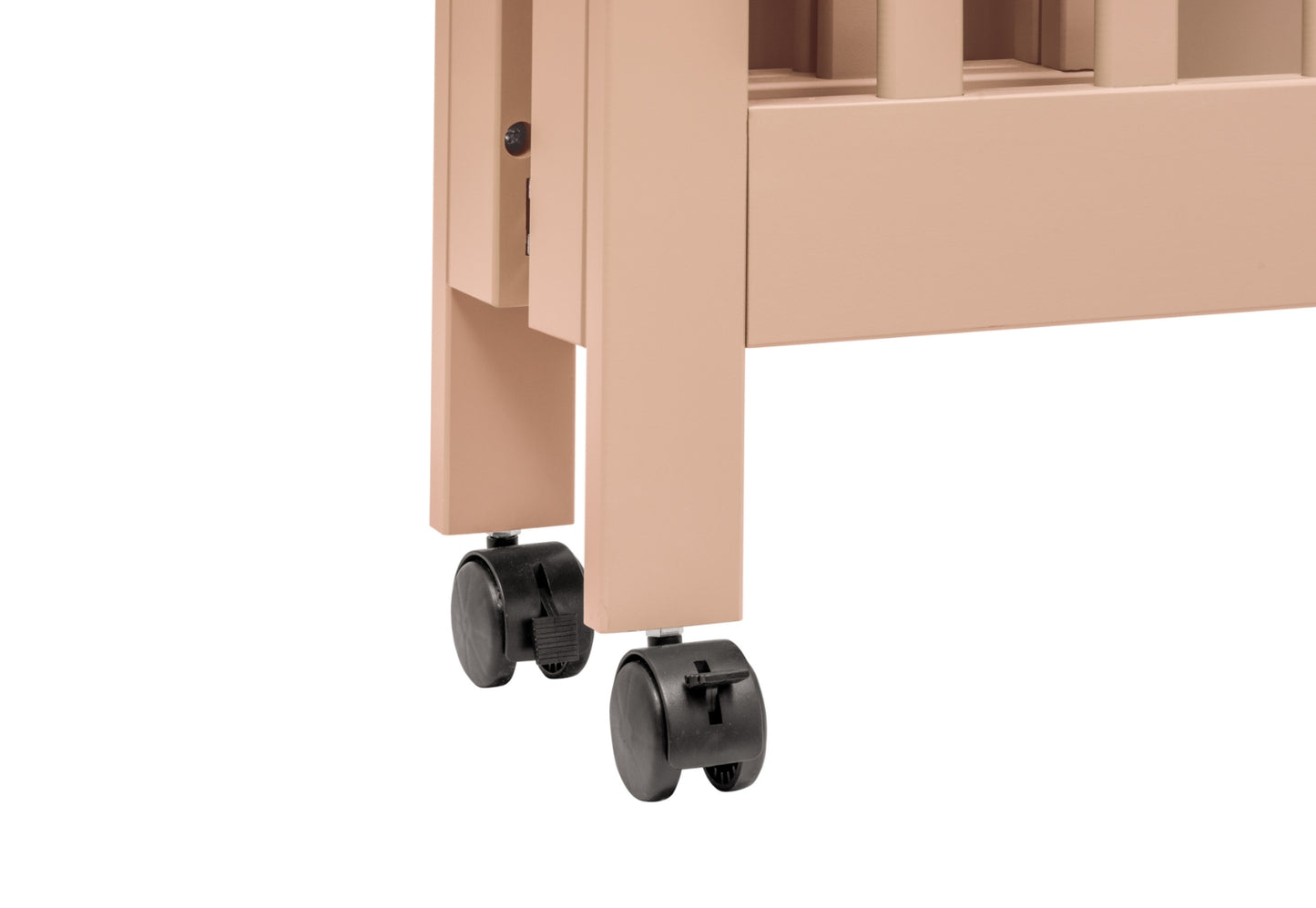 Close-up of a crib's lower corner showing its wheels and part of its frame, in a peach color.