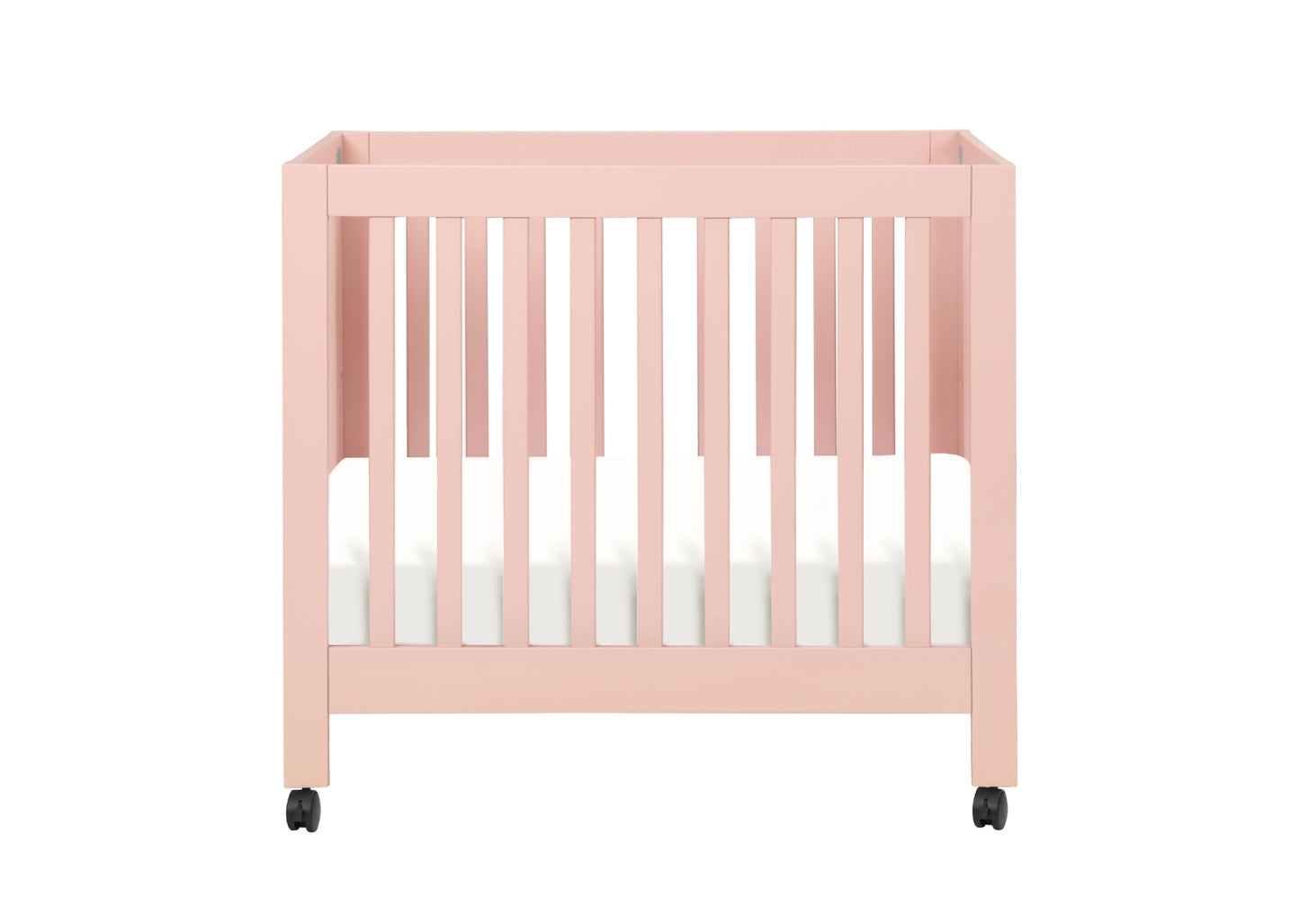 Pink baby crib on wheels with a white mattress, isolated on a white background.