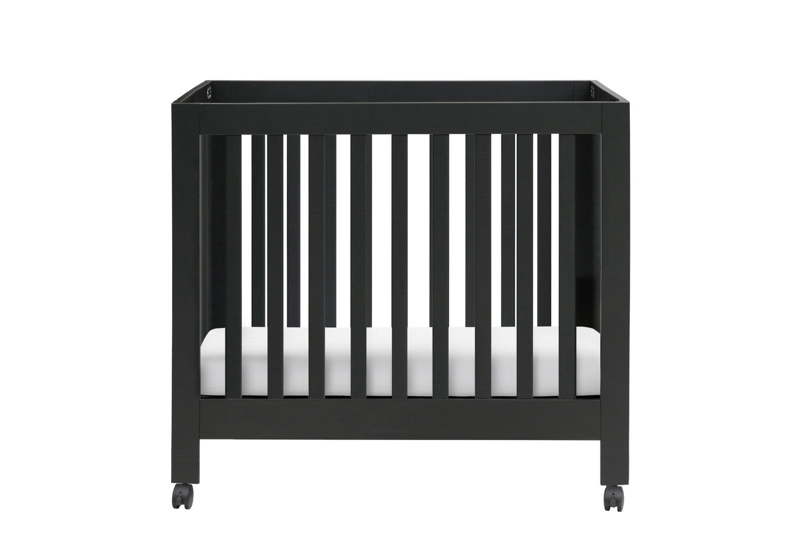 Modern black crib on wheels with visible mattress against a white background.