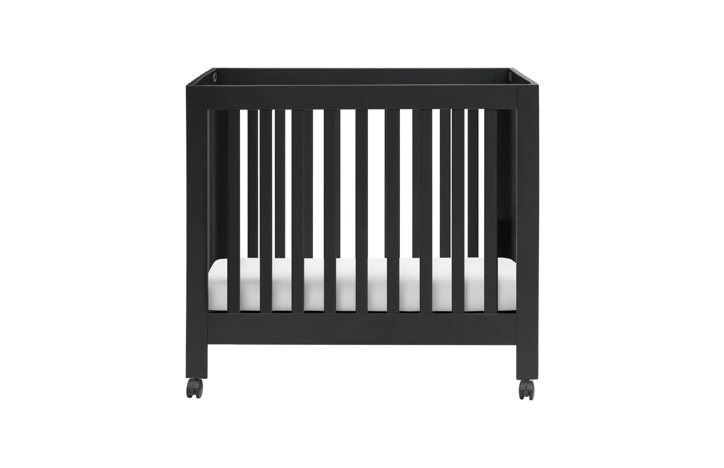 The Babyletto Origami Mini Crib is a modern black crib with vertical slats, a white mattress, and wheels for easy portability—ideal for small spaces and pictured against a plain white background.