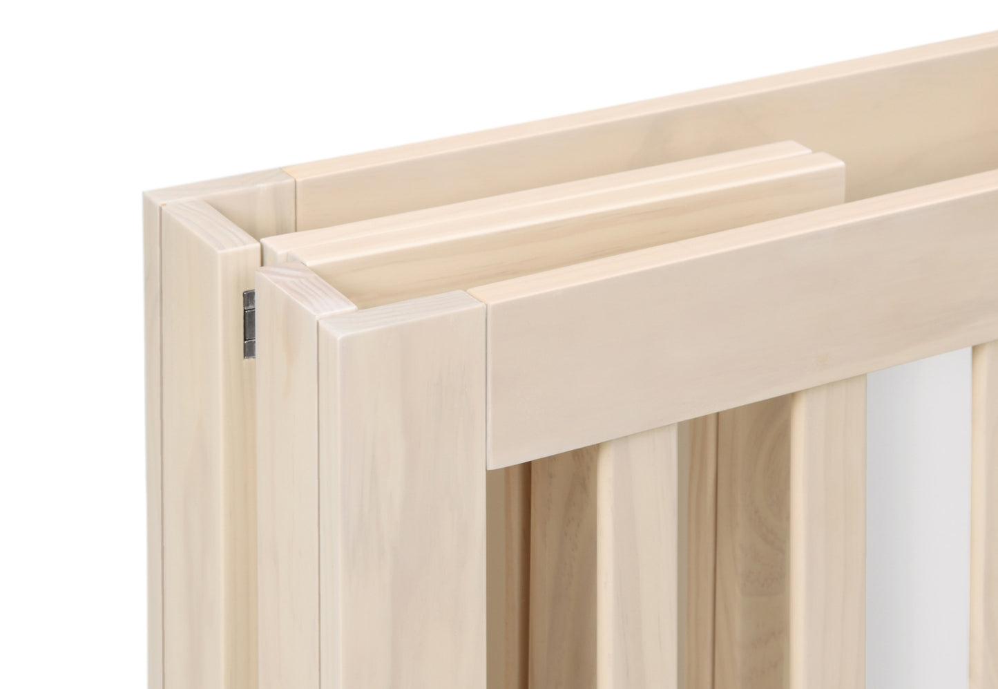 Close-up of a light wood baby crib's corner construction, showcasing its clean and simple design without any text.