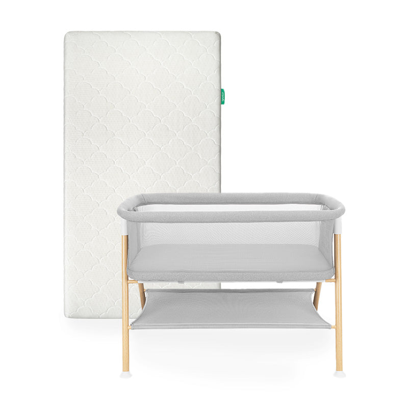 Newton waterproof mattress next to essential bassinet on a white background 1001-wht-8401