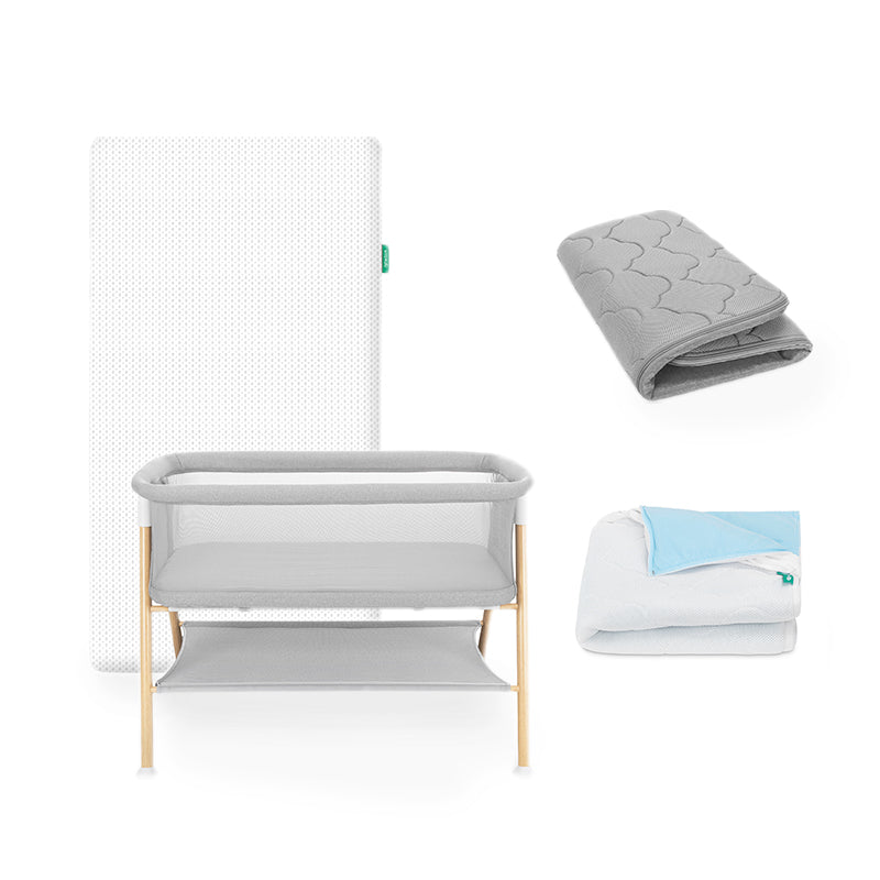 Essential bassinet, essential mattress, waterproof pad and extra bassinet cover on white background