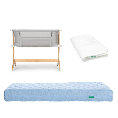 The Newton Baby Bundle 6 BFCM includes a wooden and fabric bassinet, a folded white sheet, and a light blue quilted mattress, all displayed on a white background.