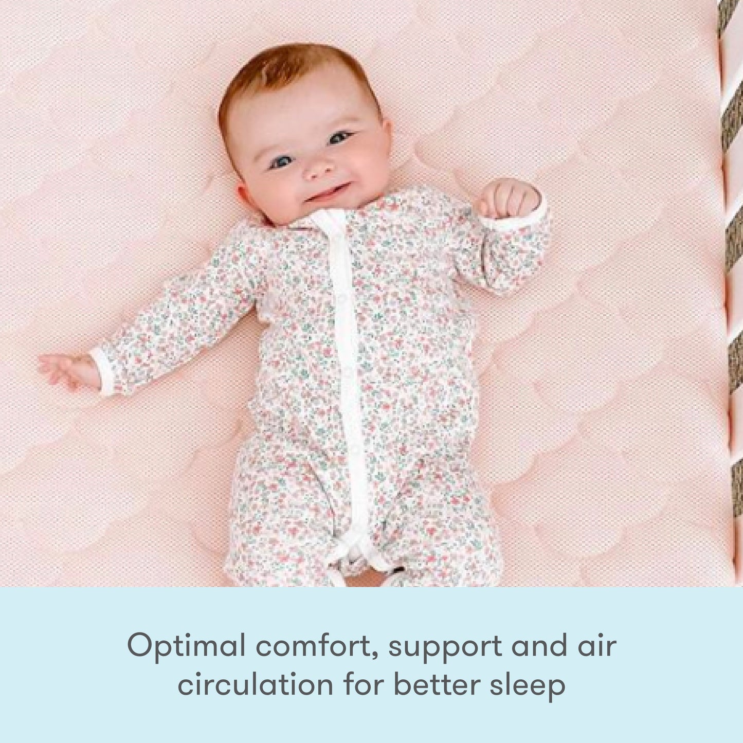A cheerful baby laying on a pink, cloud-patterned mattress, smiling at the camera. with text "optimal comfort support and air circulation for better sleep"