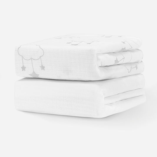 ALT text: "A stack of two white baby crib sheets with subtle cloud and star patterns, designed for comfort and safety." skip
