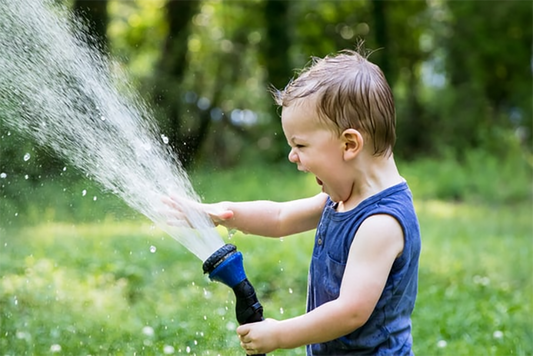 Kid playing with water hose