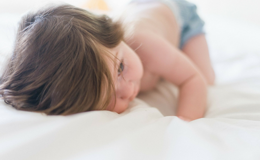 Baby laying on face and stomach 