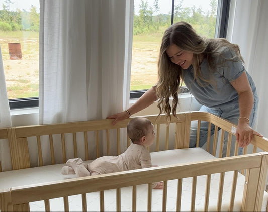 Mom checking in on back in crib
