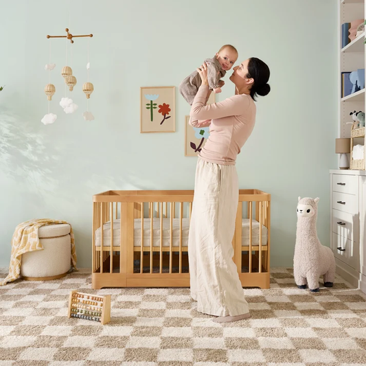 Mom picking up baby who is on baby nap schedule