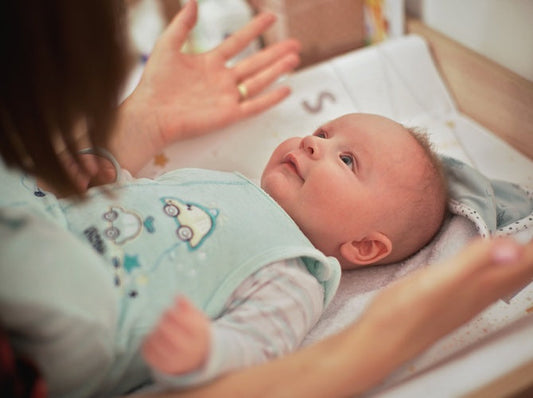 Mom changing baby