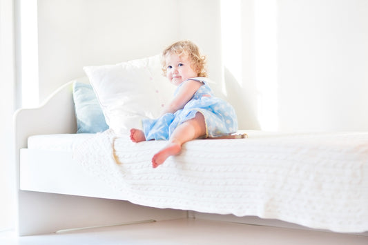Toddler laying in new bed 