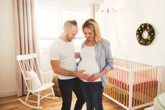 Pregnant woman with dad holding pregnant belly