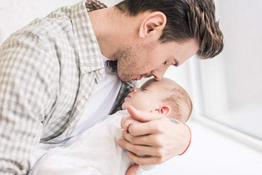 dad holding a sleeping baby