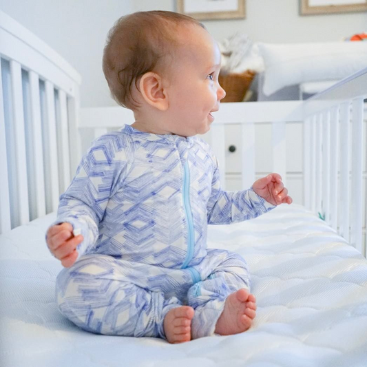 Baby sitting up in crib