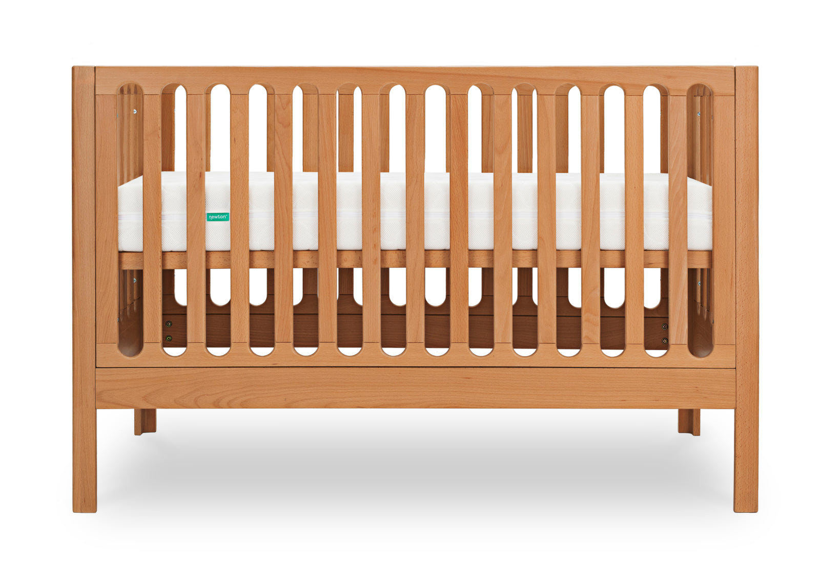 A sturdy wooden baby crib featuring spaced vertical slats and a Newton mattress with visible green branding.