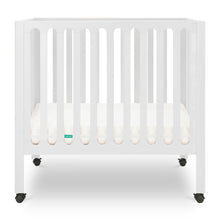 White modern baby crib with a thin mattress on wheels. 999-8430-WHT