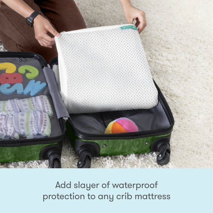A person packs the folded Newton Baby Essential Waterproof Crib Pad into a suitcase with colorful baby items, above the text: Add waterproof protection to any crib mattress.