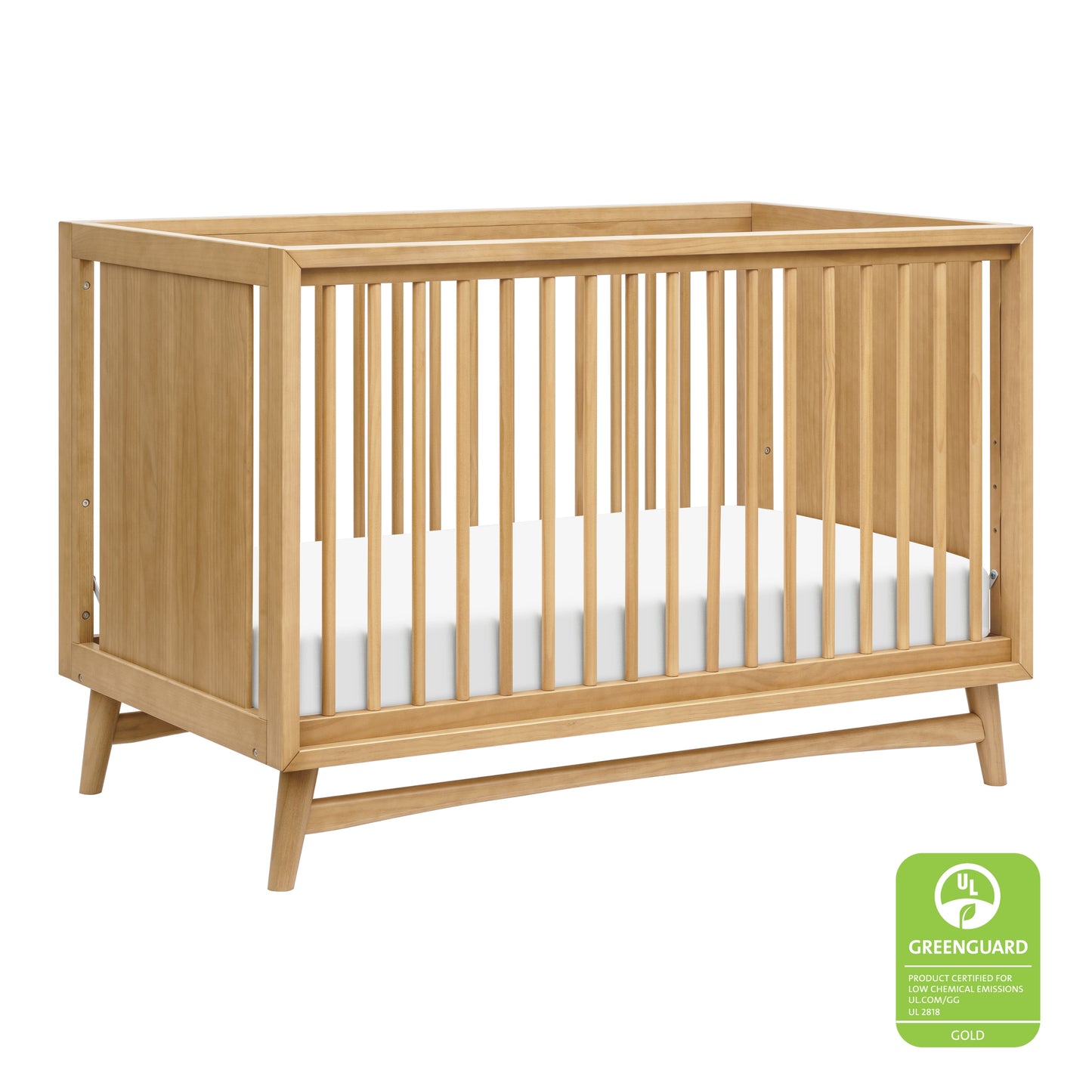 The Babyletto Peggy Convertible Crib features vertical slats on all sides, a white mattress, and angled legs—showcasing subtle mid-century style that's perfect for any modern nursery. 999-8504-HNY