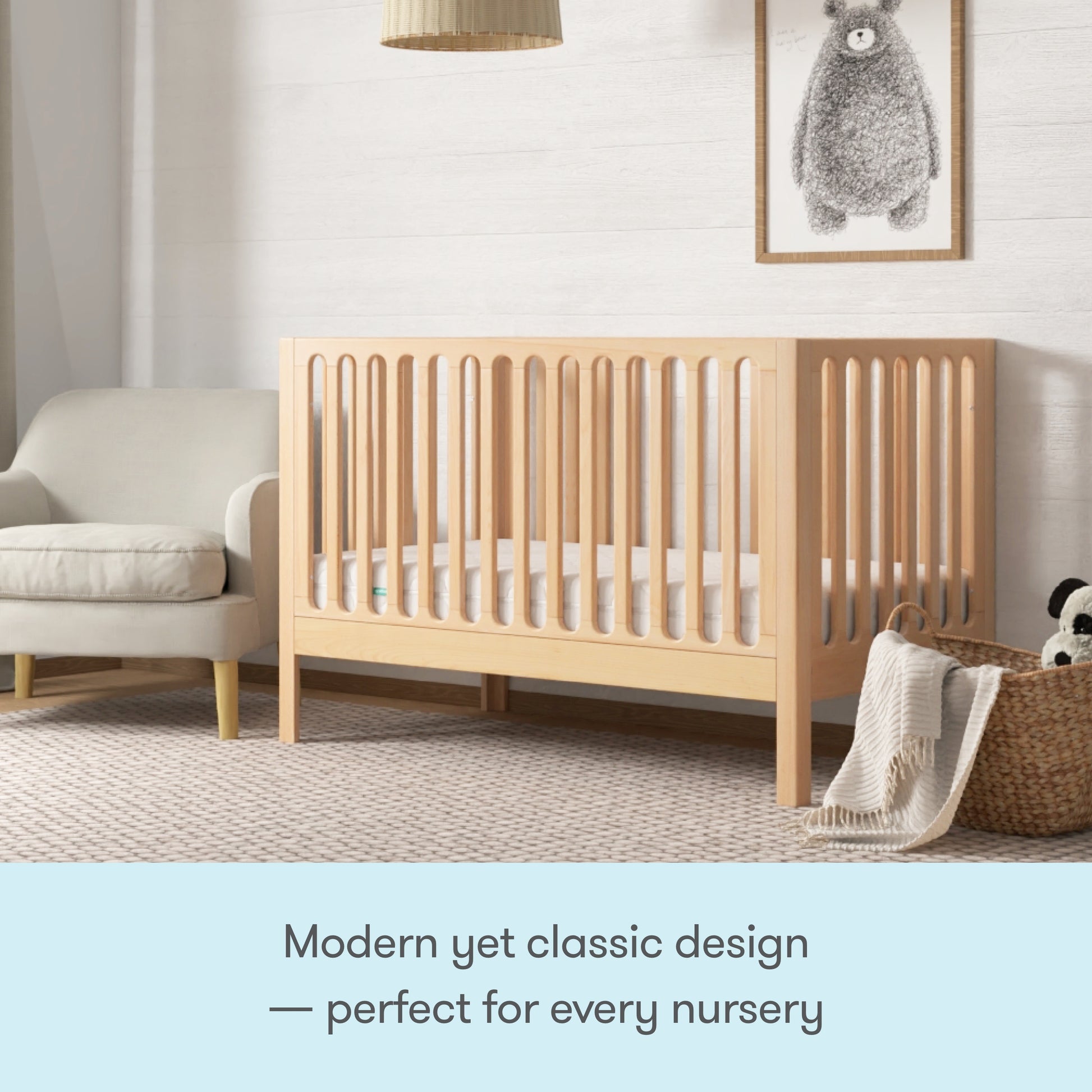 The Newton Galileo Convertible Crib by Newton Baby, with vertical slats and beech wood, brings modern yet classic style to any nursery. Easily converts to a toddler bed for growing kids—perfect beside your favorite armchair and blanket basket.