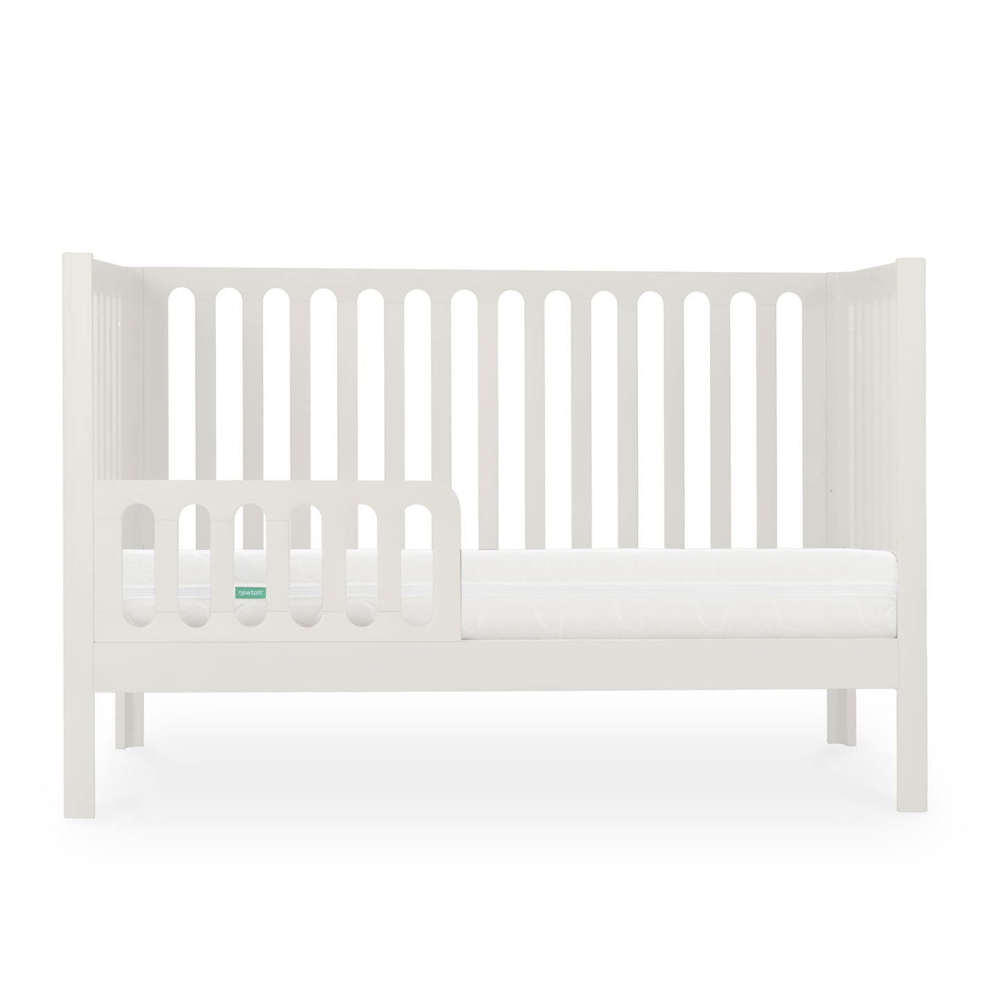 The Newton Galileo Convertible Crib by Newton Baby features white beech wood, vertical slats, an open side with a toddler rail, and a white mattress that showcases its toddler bed conversion against a plain white background.