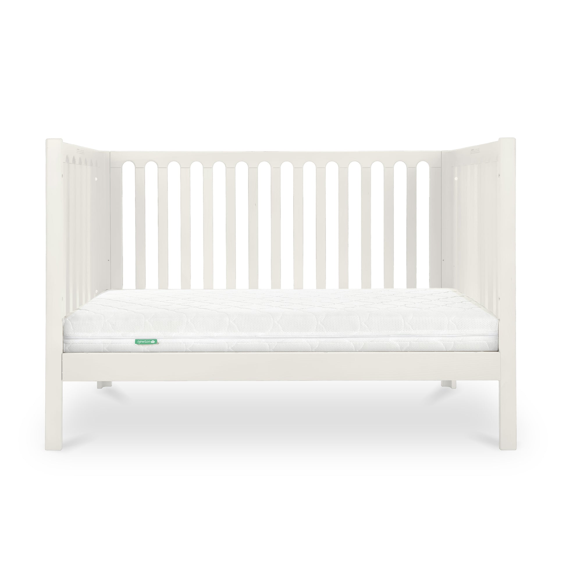 The Newton Galileo Convertible Crib by Newton Baby features white beech wood with vertical slats and a white mattress, set against a plain background. It easily converts from crib to toddler bed to suit your child’s needs.